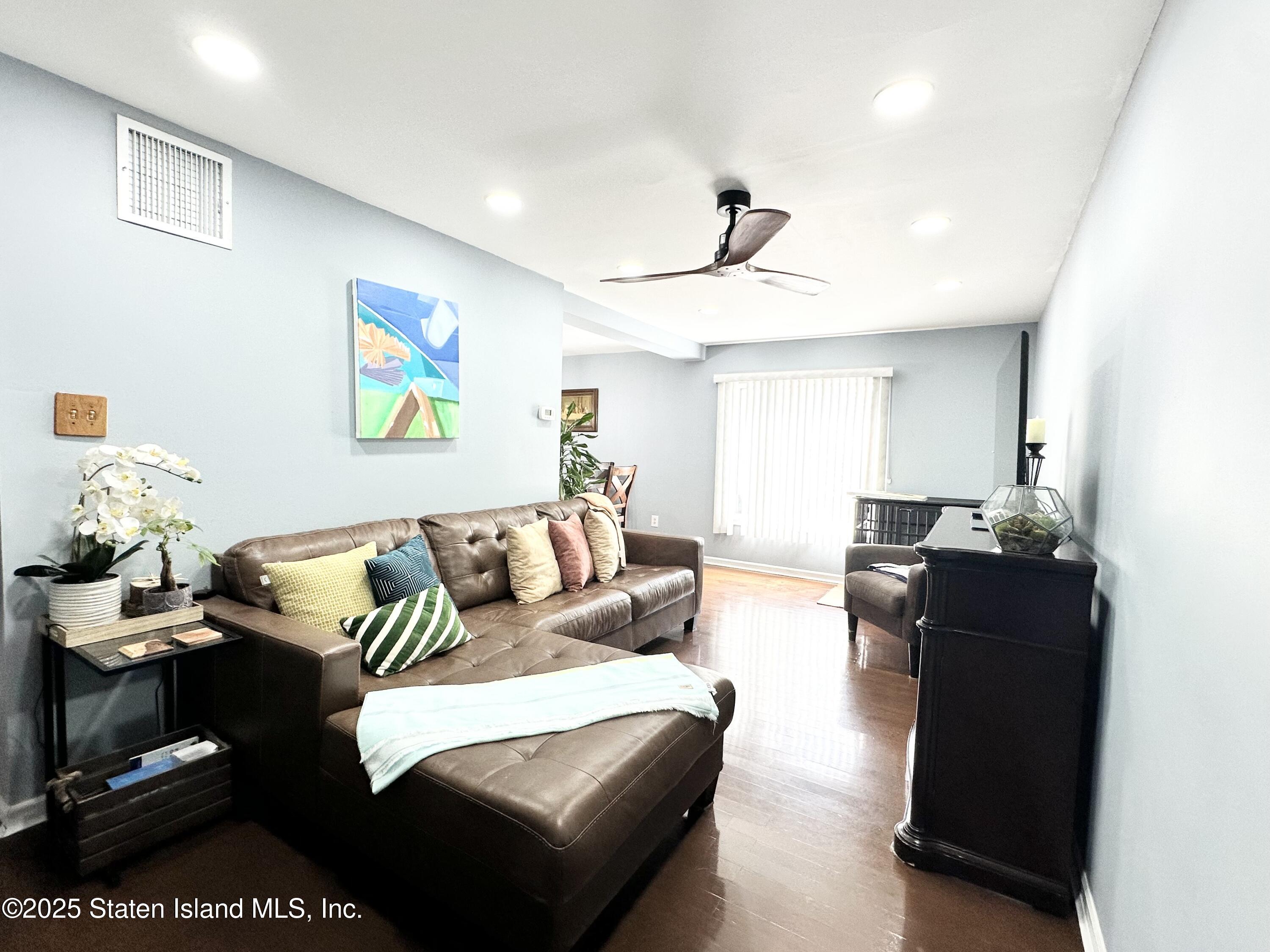 453 Ilyssa Way Staten Island, NY 10312 - Photo 3 of 16 a living room with furniture and painting on the wall