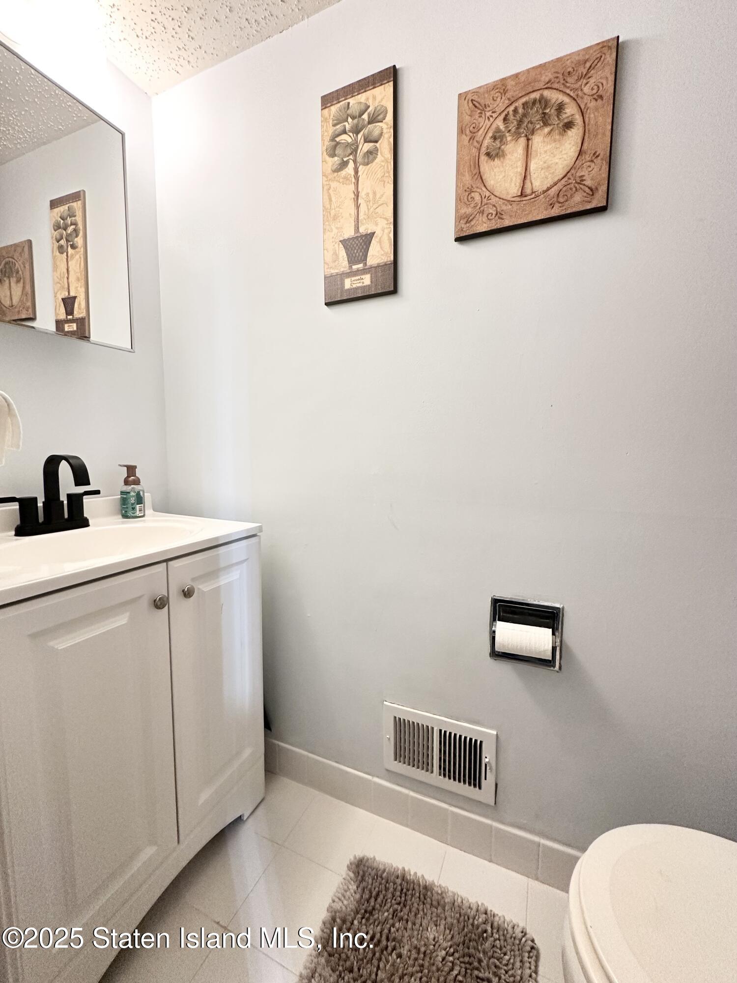 453 Ilyssa Way Staten Island, NY 10312 - Photo 6 of 16 a bathroom with a toilet and a sink