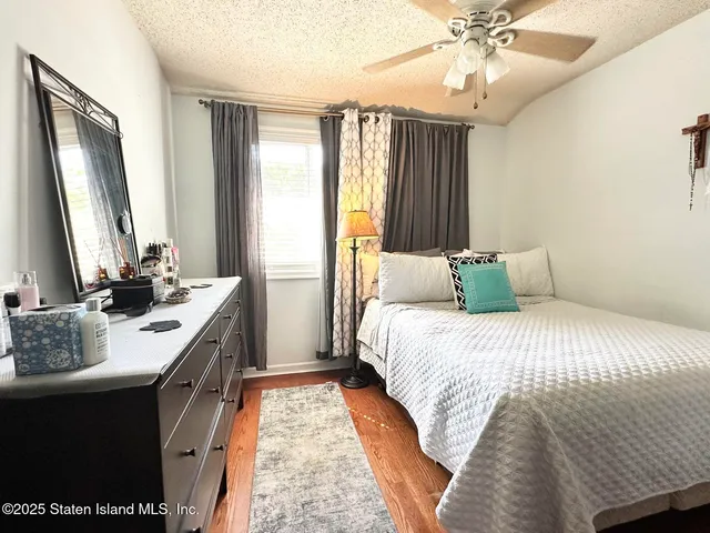 a bedroom with a bed and a mirror