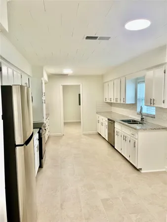 a kitchen with stainless steel appliances a refrigerator and a stove