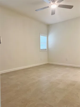 an empty room with a chandelier fan