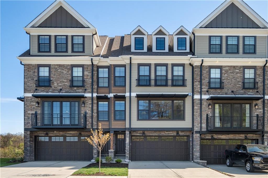 a front view of a residential apartment building with a yard