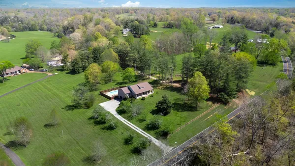 an aerial view of a house with a yard