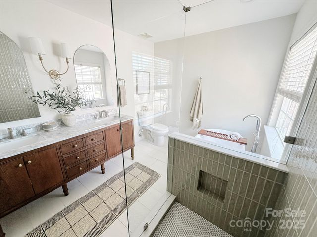 a bathroom with a double vanity sink mirror and
