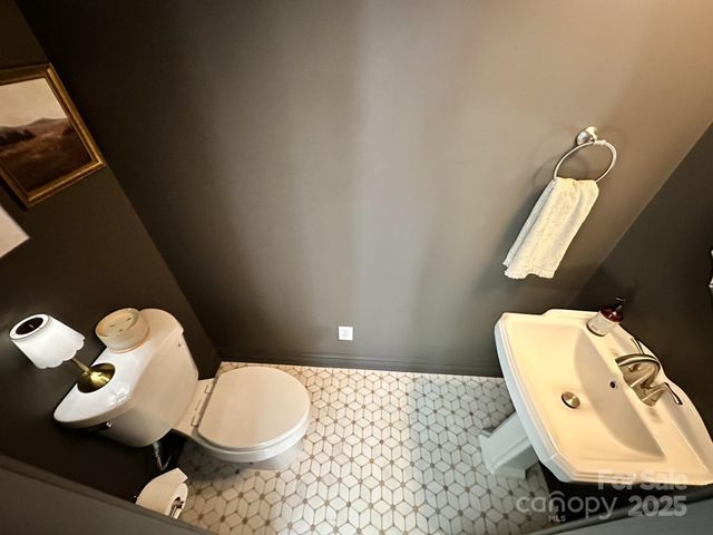 a bathroom with a toilet and a mirror