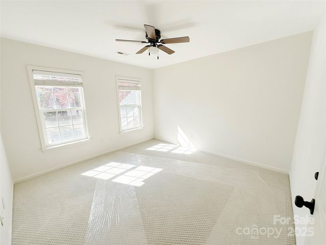 a view of a livingroom with a ceiling fan and window