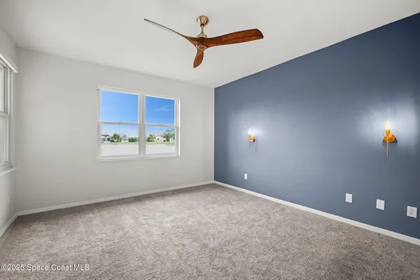 a view of a hallway with a ceiling fan