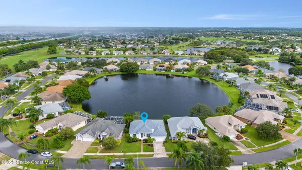 an aerial view of residential houses with outdoor space and river