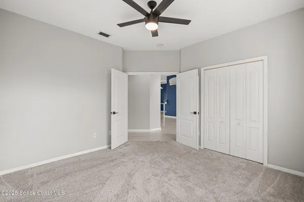 an aerial view of a house with a garden and lake view in back