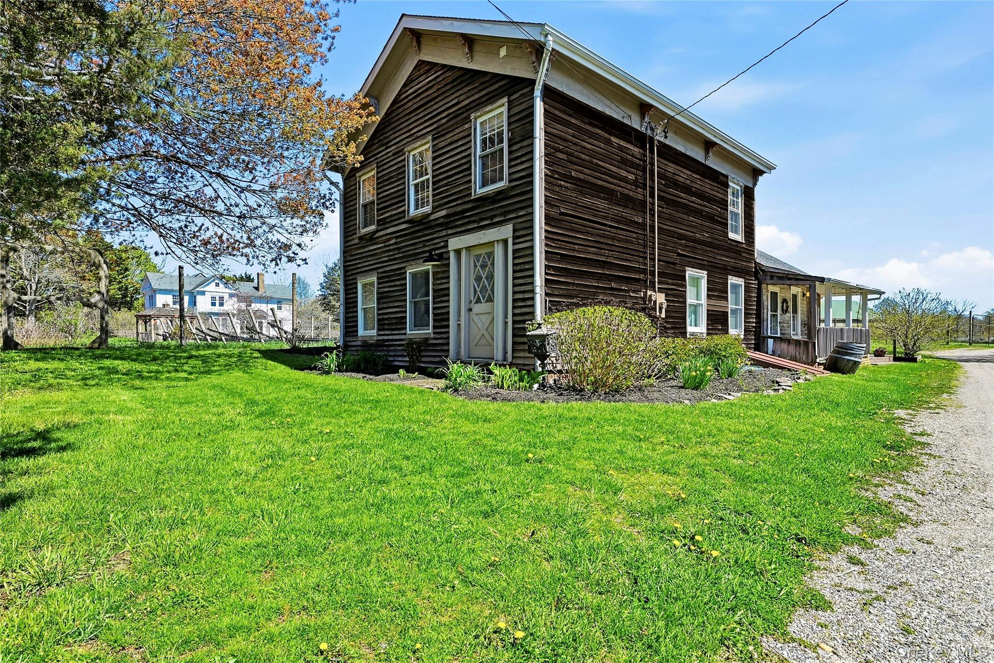 35950 Main Road Cutchogue, NY 11935 - Photo 2 of 23 a front view of a house with garden