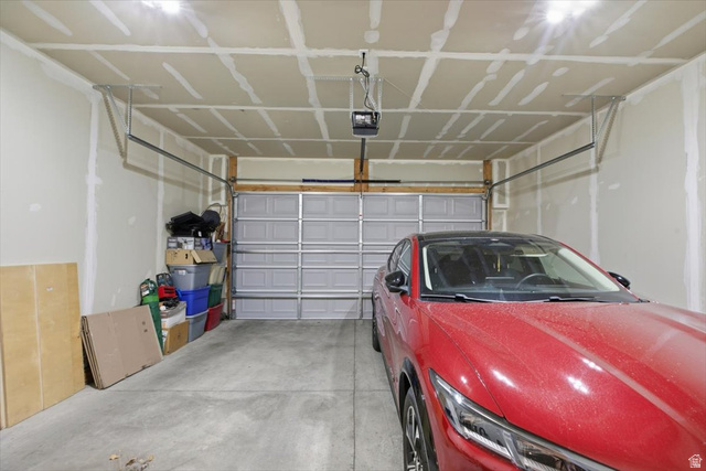 1213 West 1820th Street South Logan, UT 84321 - Photo 17 of 18 Interior garage featuring concrete flooring, a paneled garage door, and visible ceiling joists