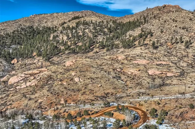 a view of a building with mountains in the background