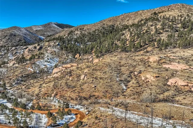 a view of a large building with mountains in the background