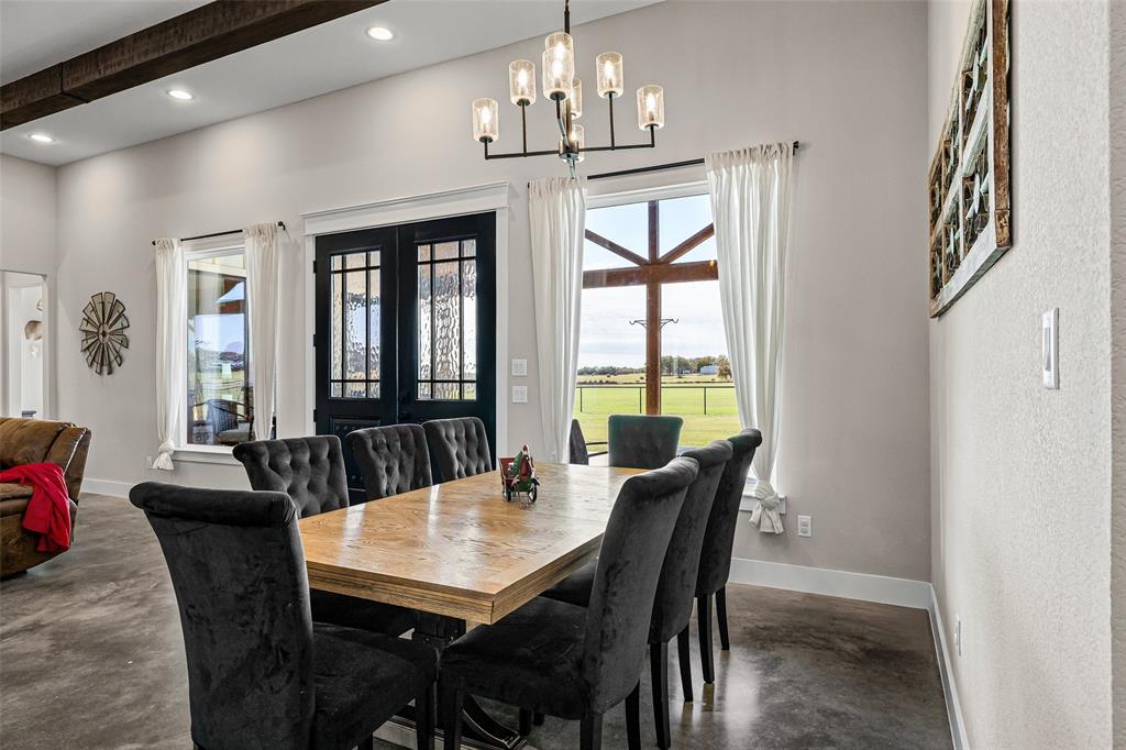 310 Runyan Rnch Road Tolar, TX 76476 - Photo 18 of 35 Dining space with concrete flooring, a chandelier, recessed lighting, and beamed ceiling