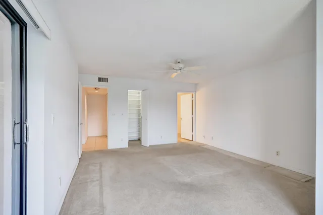 a view of walk in closet with empty racks