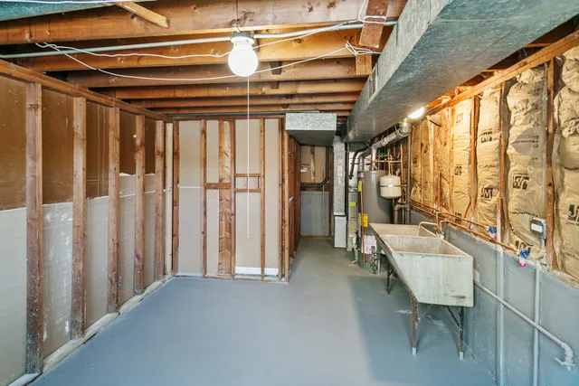 a view of a hallway with couch and chandelier