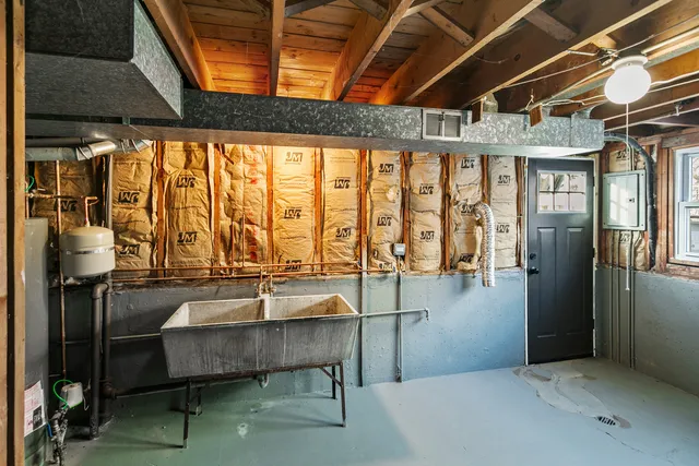 a dining room with furniture and large windows