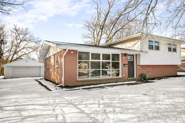 a view of a house with snow in front of house