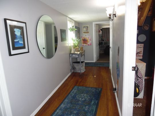 1355 South Mahan Street Ridgecrest, CA 93555 - Photo 18 of 35 a hallway with painting on the wall and a mirror