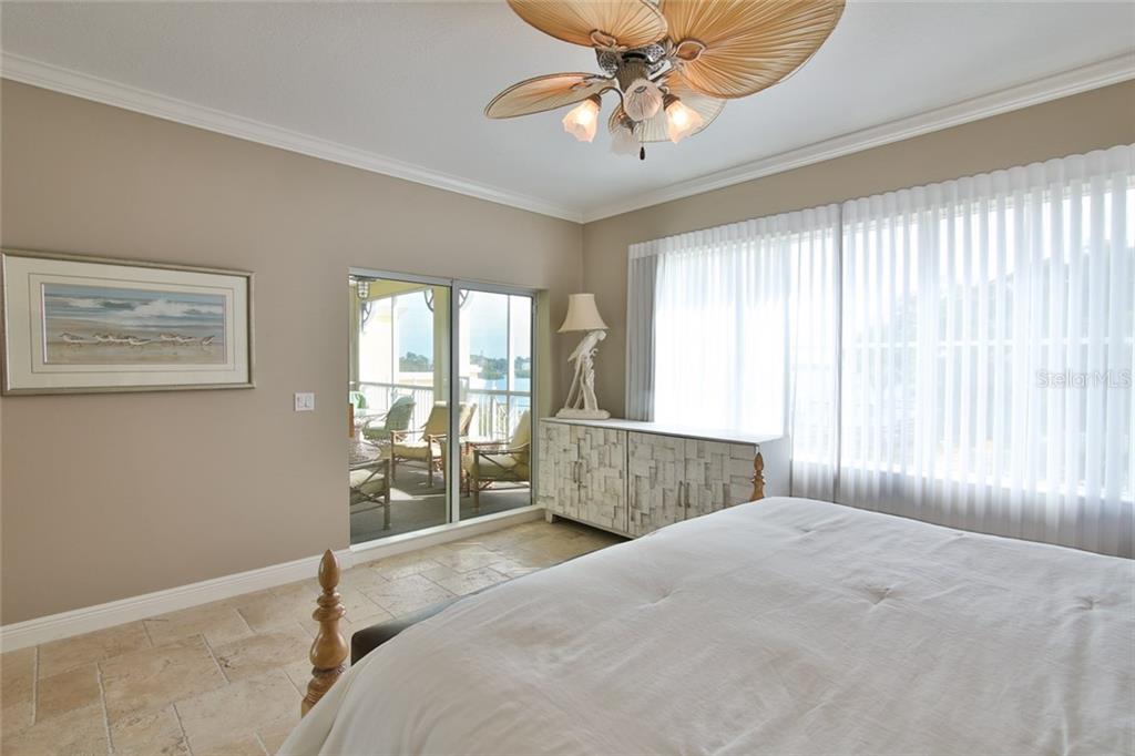 1310 Old Stickney Point Road, Unit E21 Sarasota, FL 34242 - Photo 13 of 25 Master Bedroom-lots of natural light, water view and screened balcony