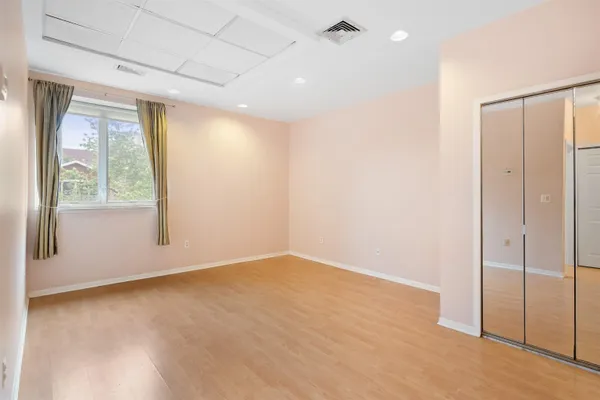an empty room with windows and closet
