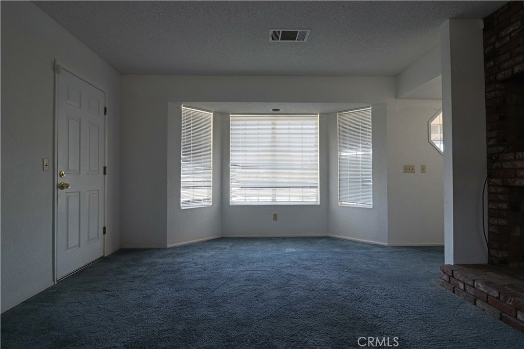 4752 Flying H Road Twentynine Palms, CA 92277 - Photo 27 of 55 an empty room with windows and closet