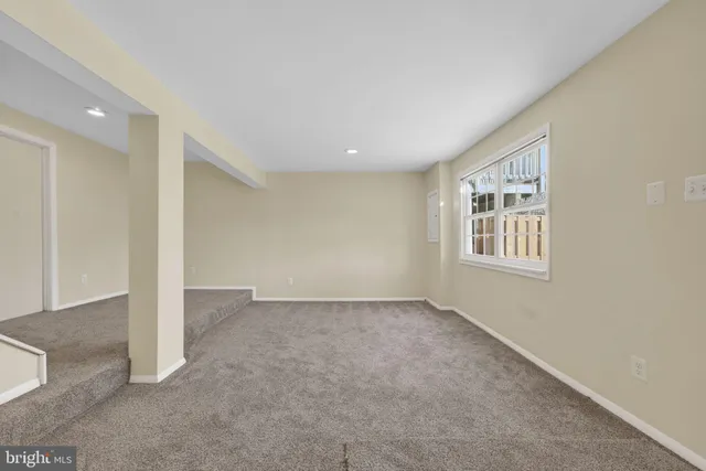 a view of an empty room with wooden walls