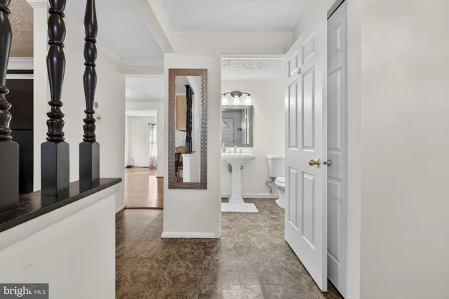 a view of a hallway with windows and brick walls