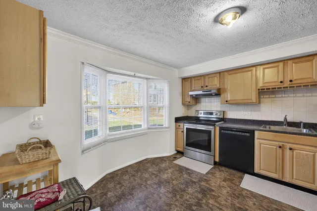 a kitchen with stainless steel appliances granite countertop a stove and a sink