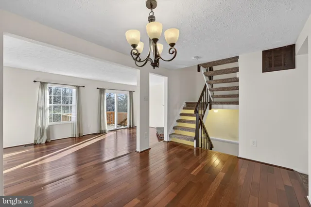 wooden floor fireplace and windows in an empty room
