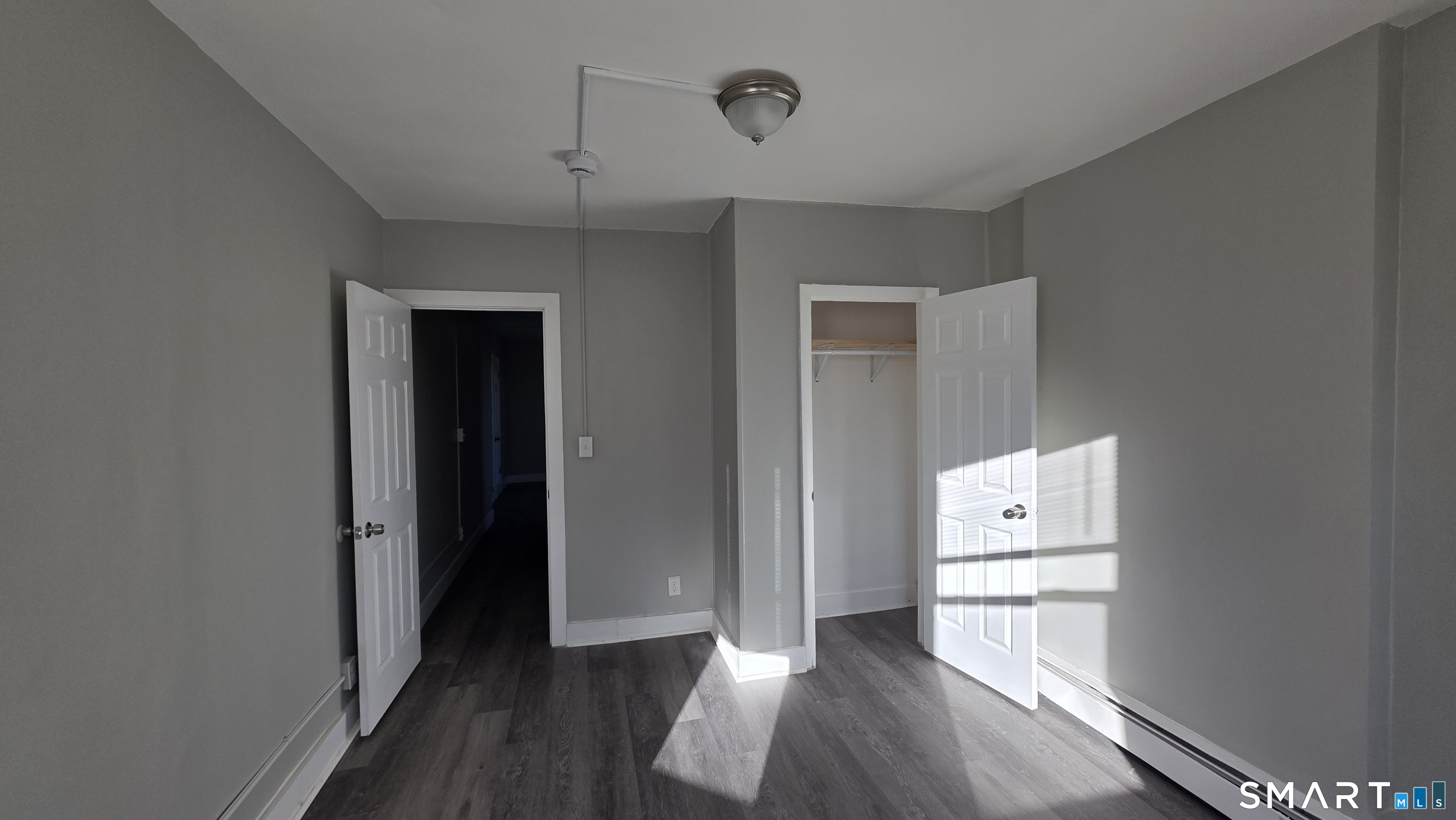 499 Zion Street, Unit 2N Hartford, CT 06106 - Photo 4 of 13 a view of room with wooden floor and closet