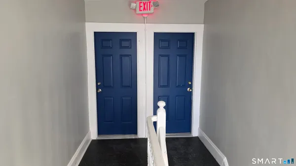 a view of room with wooden floor and closet