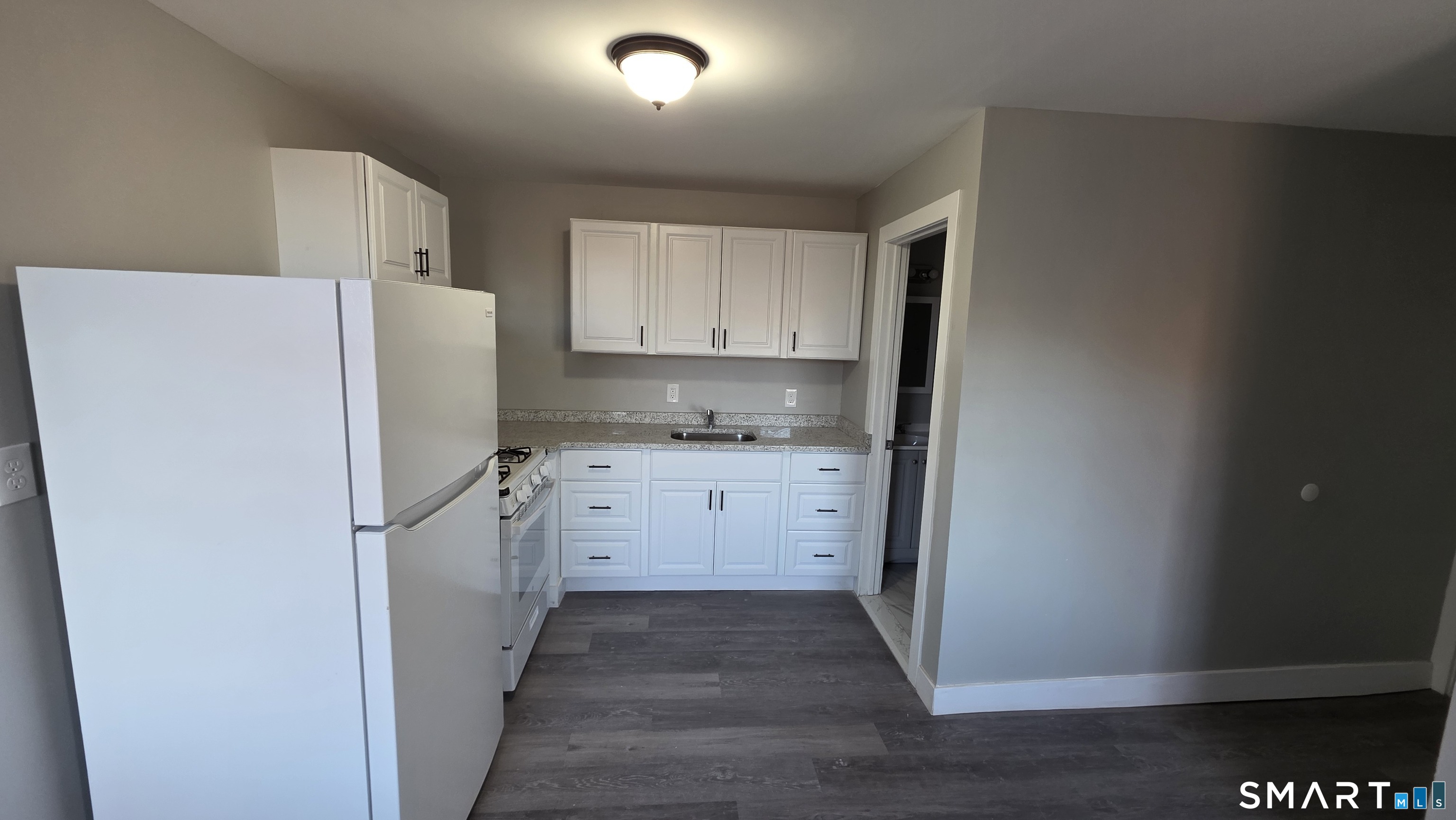 499 Zion Street, Unit 2N Hartford, CT 06106 - Photo 10 of 13 a kitchen with a refrigerator sink stove and cabinets