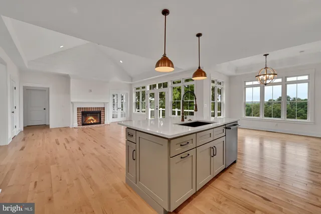 a kitchen with granite countertop a stove and a wooden floor