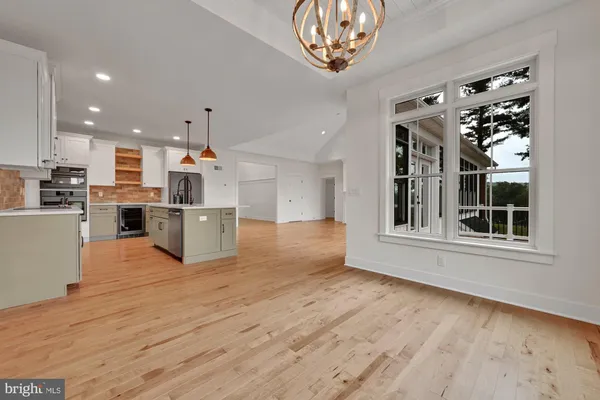 a view of a kitchen with furniture and wooden floor