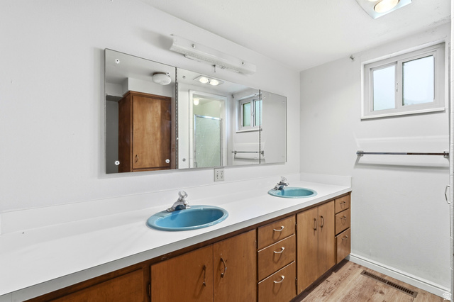 1410 Sumac Drive Logan, UT 84321 - Photo 21 of 28 Dual basin vanity with a white countertop and wood-finish cabinetry