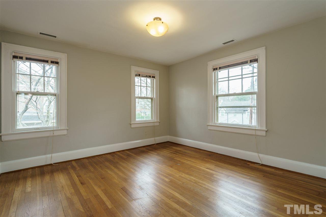 2415 Fairview Road Raleigh, NC 27608 - Photo 14 of 24 a view of an empty room with wooden floor and a window