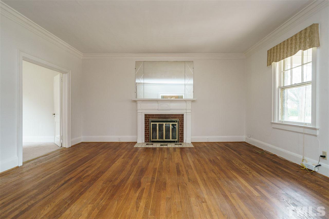 2415 Fairview Road Raleigh, NC 27608 - Photo 3 of 24 a view of an empty room with wooden floor and a window