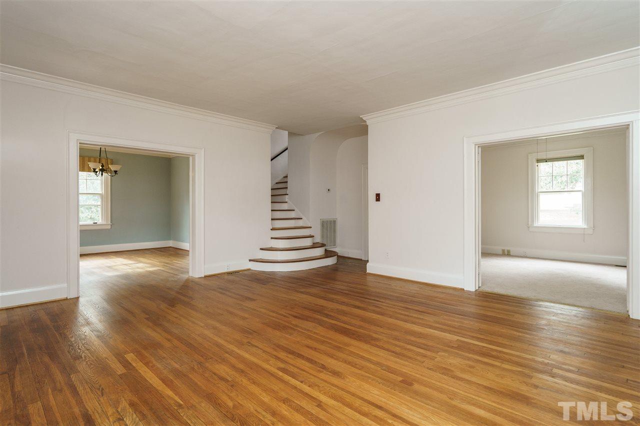 2415 Fairview Road Raleigh, NC 27608 - Photo 4 of 24 an empty room with wooden floor and windows
