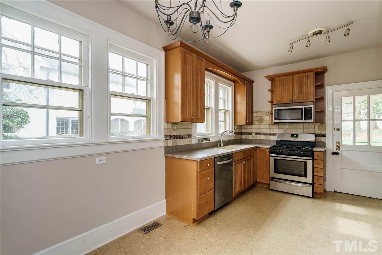 2415 Fairview Road Raleigh, NC 27608 - Photo 6 of 24 a kitchen with stainless steel appliances granite countertop a stove and a refrigerator