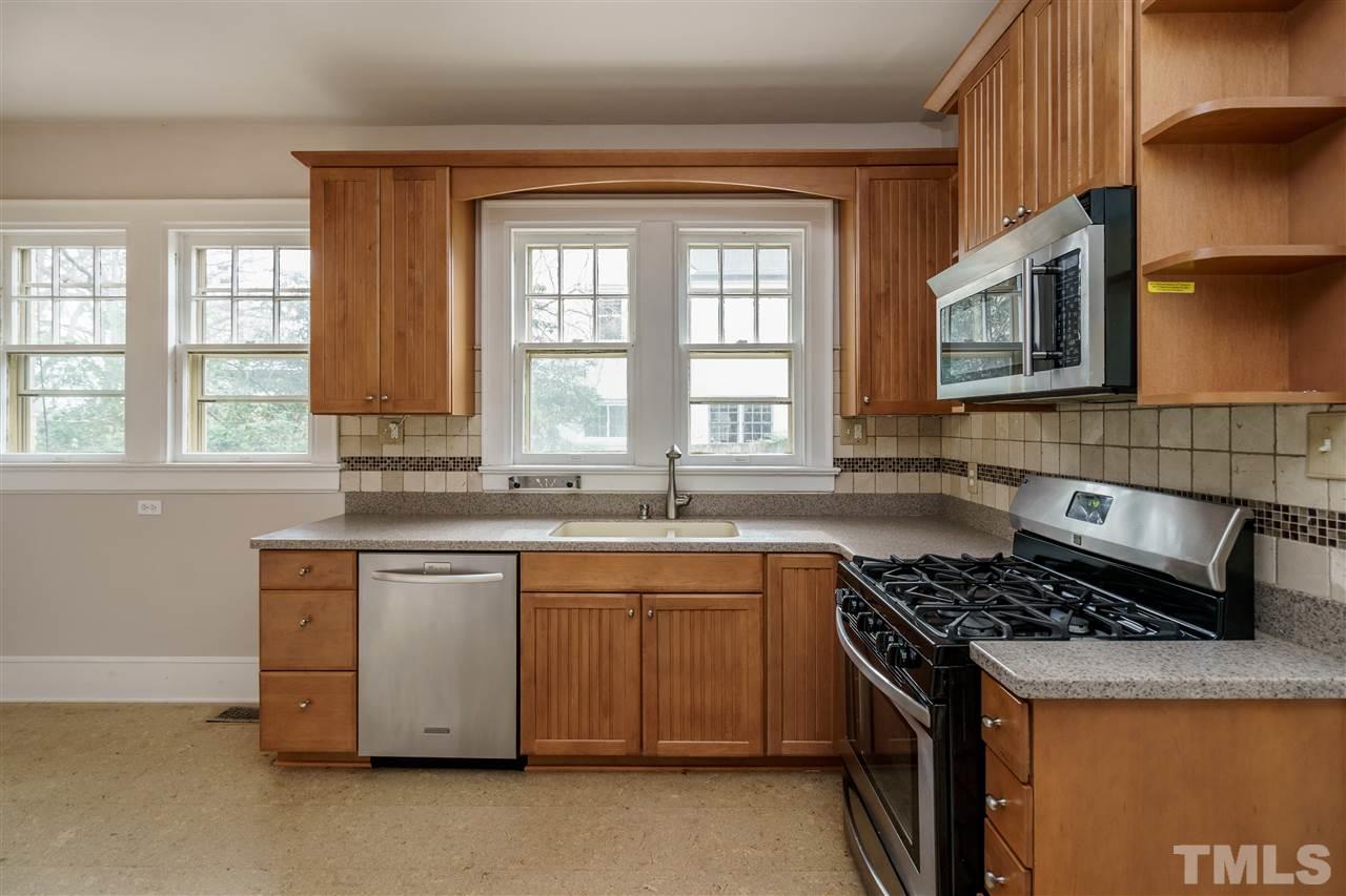 2415 Fairview Road Raleigh, NC 27608 - Photo 7 of 24 a kitchen with stainless steel appliances granite countertop a stove a sink and a microwave