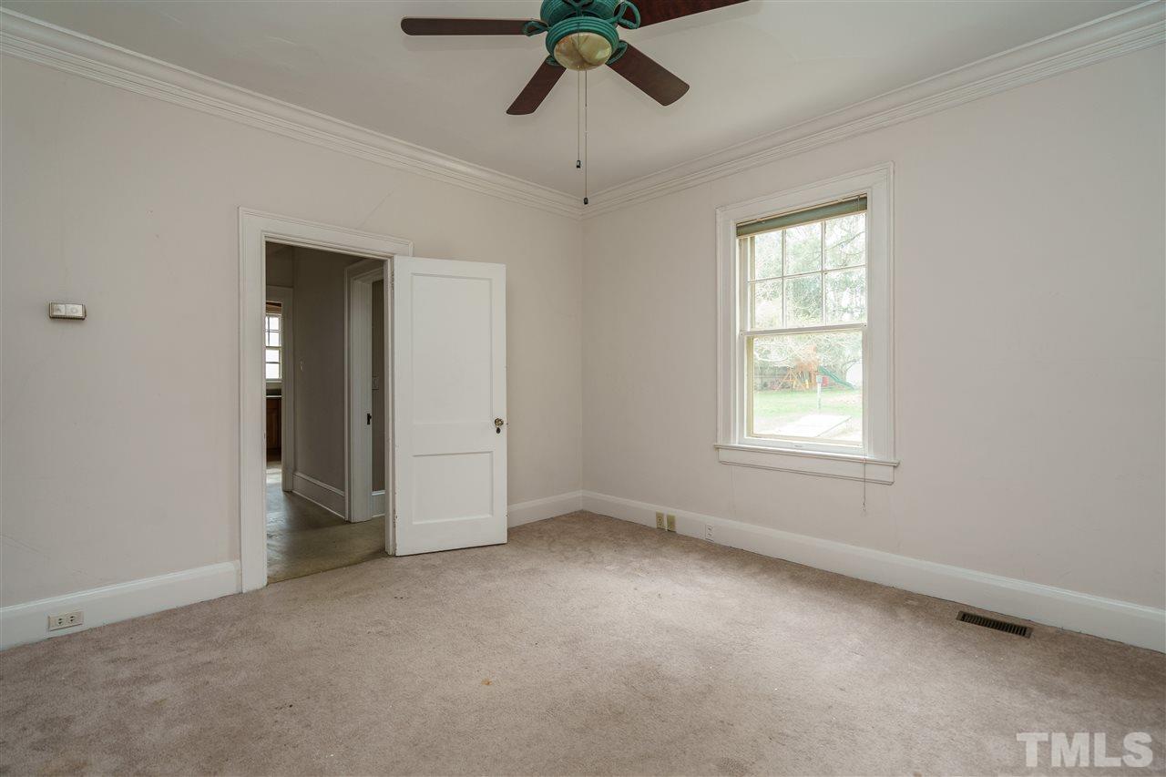 2415 Fairview Road Raleigh, NC 27608 - Photo 9 of 24 an empty room with a window and a ceiling fan