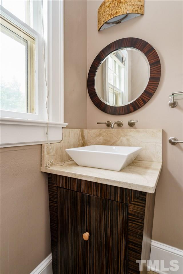 2415 Fairview Road Raleigh, NC 27608 - Photo 10 of 24 a bathroom with a sink and a mirror