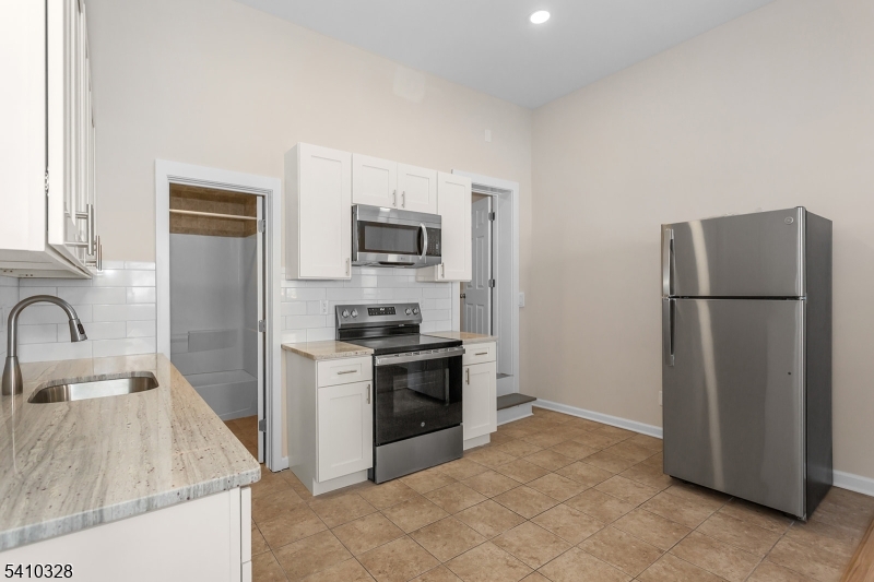 129 Main Street, Unit 3 Bloomingdale, NJ 07403 - Photo 11 of 21 a kitchen with a refrigerator stove and sink