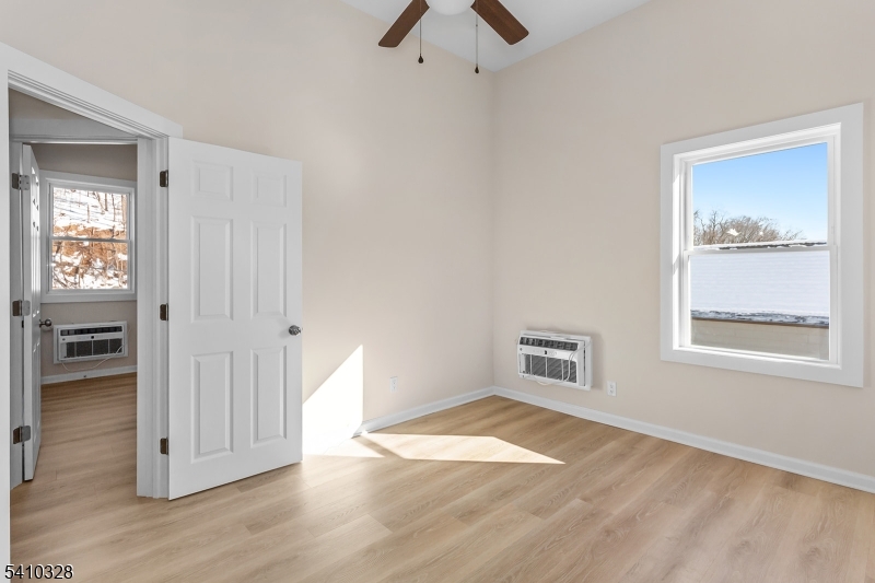 129 Main Street, Unit 3 Bloomingdale, NJ 07403 - Photo 14 of 21 wooden floor and windows in a room
