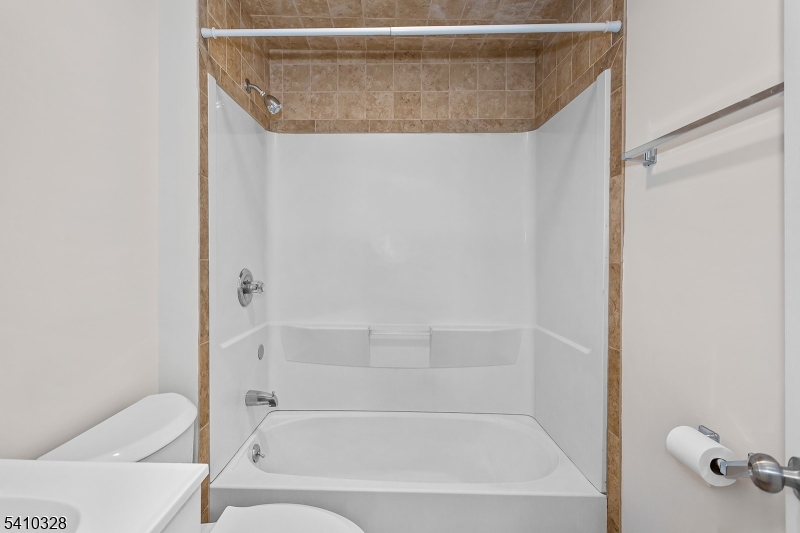 129 Main Street, Unit 3 Bloomingdale, NJ 07403 - Photo 16 of 21 a bathroom with a bathtub and shower