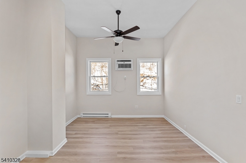 129 Main Street, Unit 3 Bloomingdale, NJ 07403 - Photo 4 of 21 wooden floor in an empty room with a window