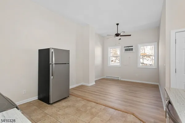 an empty room with windows and closet