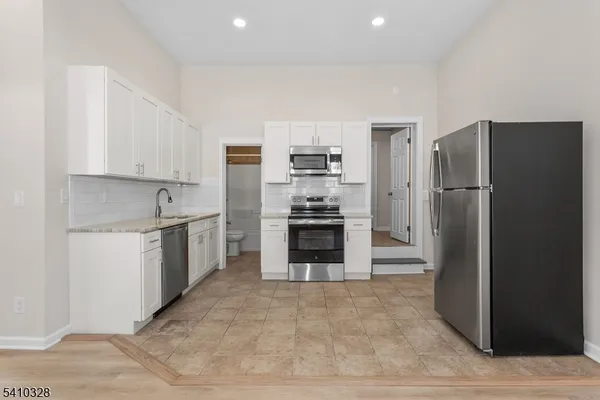 a kitchen with a refrigerator sink and stove