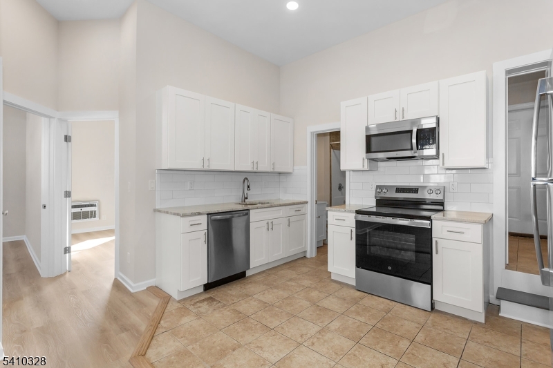 129 Main Street, Unit 3 Bloomingdale, NJ 07403 - Photo 9 of 21 a kitchen with a stove top oven and refrigerator